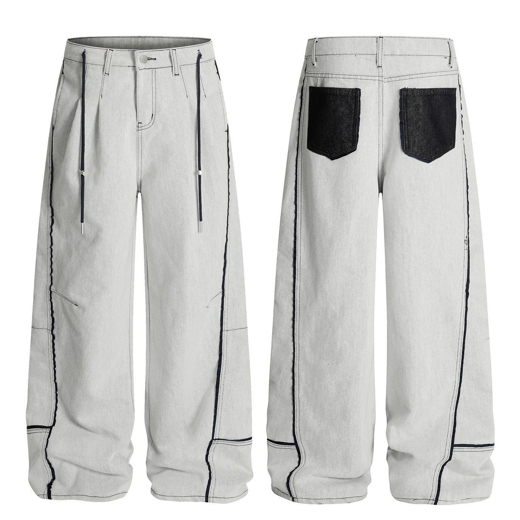 Washed distressed deconstruction with visible stitching and drawstring jeans