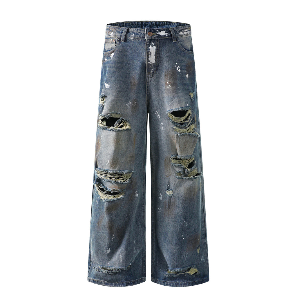 Mud stained denim jeans with holes