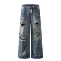 Mud stained denim jeans with holes