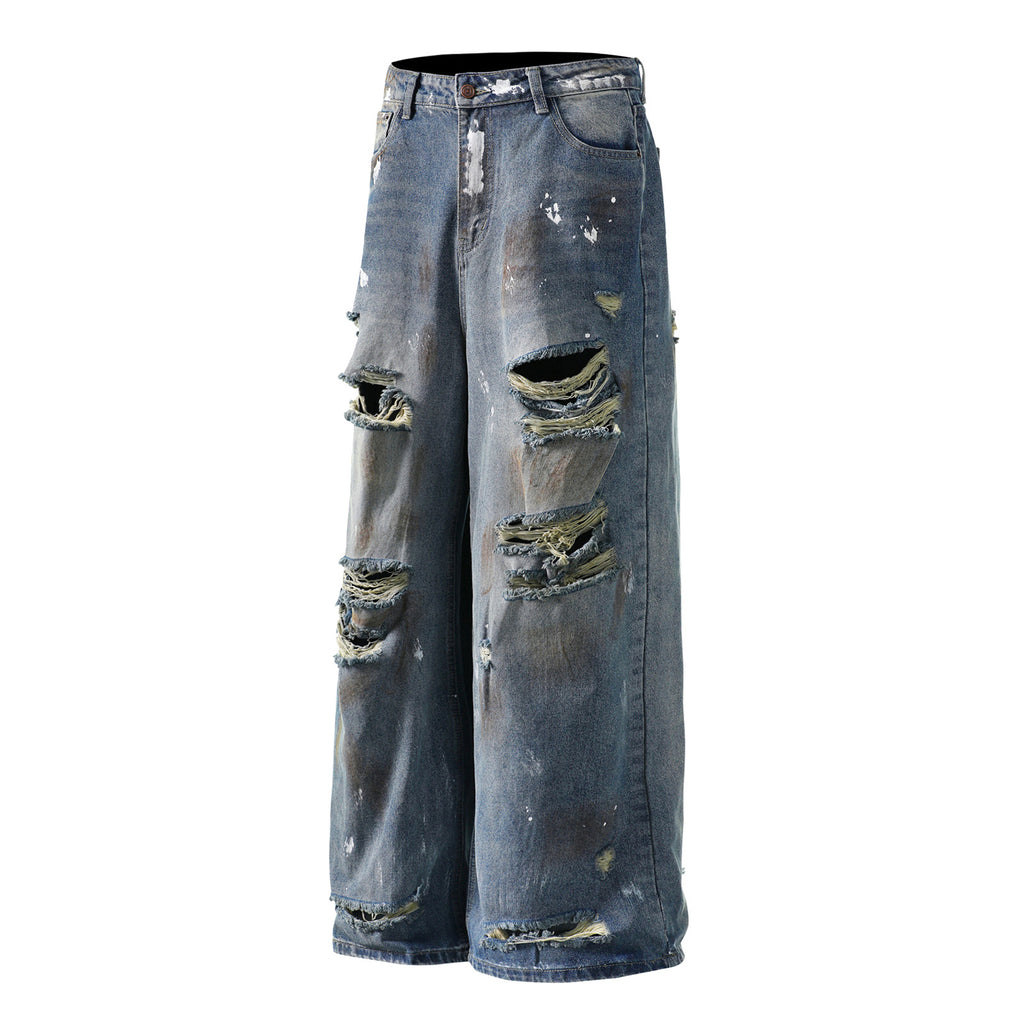 Mud stained denim jeans with holes