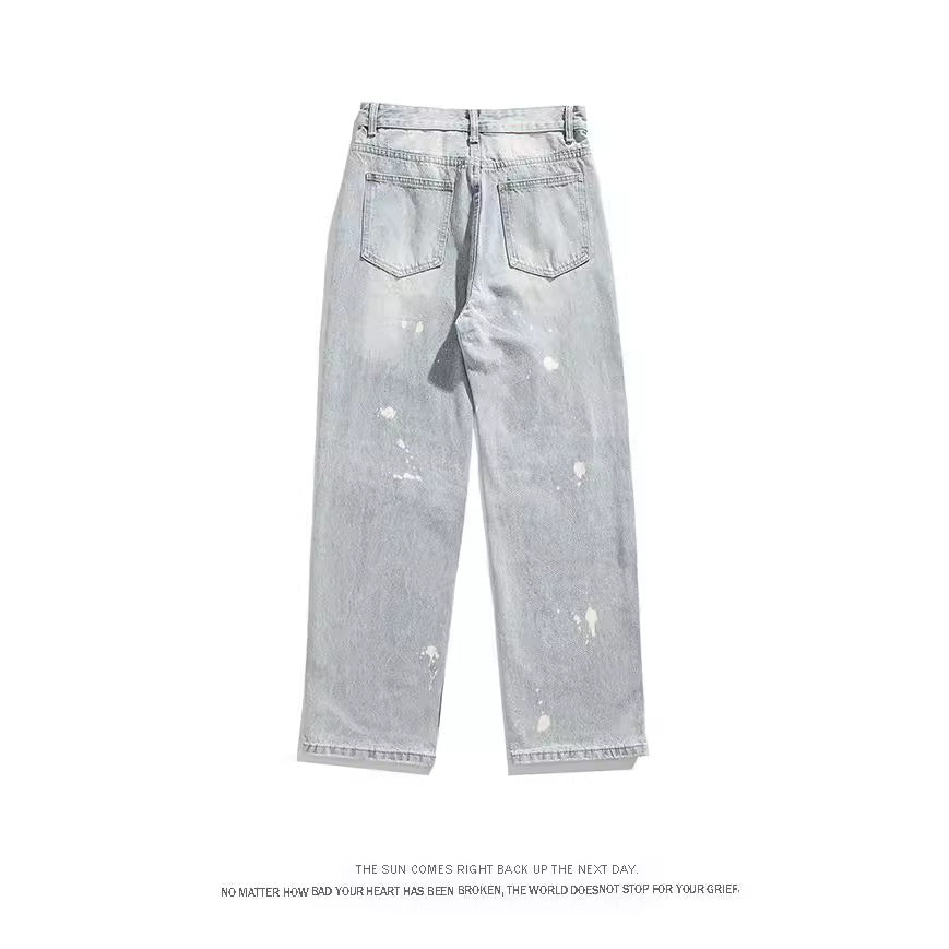 Ink splattered distressed men's jeans with holes